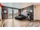 A living room with cityscape view, cozy couch, and a cat climbing tree at 8475 E 36Th Ave # 337, Denver, CO 80238