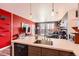 A modern kitchen featuring a breakfast bar overlooking a living room with a balcony at 8475 E 36Th Ave # 337, Denver, CO 80238