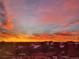 Vibrant sunrise over the neighborhood features an array of pink, orange, and blue hues in the sky at 8475 E 36Th Ave # 337, Denver, CO 80238