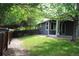 Backyard featuring green grass and stone path leading to fenced yard at 213 Mesa St, Brighton, CO 80601