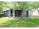 A lush backyard with mature trees and green grass at 213 Mesa St, Brighton, CO 80601