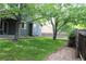Backyard with green grass and stone pathway at 213 Mesa St, Brighton, CO 80601