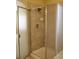 Bathroom showing glass enclosed shower with tile walls at 213 Mesa St, Brighton, CO 80601