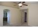 Bright bedroom with arched doorway to bathroom and ceiling fan at 213 Mesa St, Brighton, CO 80601