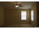 Bedroom featuring a ceiling fan and bright windows at 213 Mesa St, Brighton, CO 80601