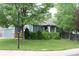 Inviting one-story house with landscaped yard and well-maintained exterior at 213 Mesa St, Brighton, CO 80601