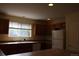 Kitchen featuring countertops, a sink, window, white fridge and oak cabinets at 213 Mesa St, Brighton, CO 80601