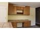 Bright kitchen with tile countertops and oak cabinets at 213 Mesa St, Brighton, CO 80601