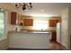 Well lit kitchen featuring countertops, white fridge, and oak cabinets at 213 Mesa St, Brighton, CO 80601