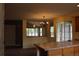Open kitchen with bright lighting and tile countertops and backsplash at 213 Mesa St, Brighton, CO 80601