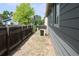 A side yard is graveled with a newer A/C unit at 213 Mesa St, Brighton, CO 80601