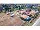 Aerial view of property with horse facilities, barns, and paddocks in a suburban setting at 5400 S Alkire St, Littleton, CO 80127