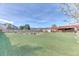 Manicured lawn features landscaping, a pond, and view of covered porch and deck at 5400 S Alkire St, Littleton, CO 80127