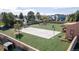 Spacious backyard featuring a basketball court, pond, and artificial turf at 5400 S Alkire St, Littleton, CO 80127