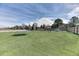 Manicured backyard includes a trampoline, pond, rock feature, and lush green grass at 5400 S Alkire St, Littleton, CO 80127
