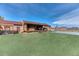 Expansive backyard featuring an inviting deck with a hot tub, a grassy area, and a basketball court at 5400 S Alkire St, Littleton, CO 80127