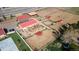 Aerial view of horse property with barns, stalls, and training area for equestrian activities at 5400 S Alkire St, Littleton, CO 80127