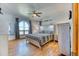 Main bedroom boasting hardwood floors, a Southwestern-style decor, and a large arched window with views at 5400 S Alkire St, Littleton, CO 80127