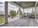 Covered porch with wood flooring, table and chairs, and fire pit area with mountain views at 9527 Iron Mountain Way, Arvada, CO 80007