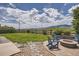 Landscaped backyard with fenced yard, stone patio, and fire pit overlooking mountain views at 9527 Iron Mountain Way, Arvada, CO 80007