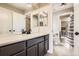 Clean bathroom with modern fixtures, vanity with storage, and opens to another bathroom and bedroom at 9527 Iron Mountain Way, Arvada, CO 80007