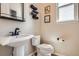 Powder room featuring a pedestal sink, black faucet, and decorative towels at 9527 Iron Mountain Way, Arvada, CO 80007