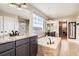 Elegant bathroom featuring a soaking tub, granite countertops, and a separate glass-enclosed shower at 9527 Iron Mountain Way, Arvada, CO 80007