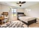 Bright bedroom with desk, large window with views, neutral decor, and stylish ceiling fan at 9527 Iron Mountain Way, Arvada, CO 80007