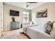 Cozy bedroom with a TV, dresser and serene decor with a window view at 9527 Iron Mountain Way, Arvada, CO 80007
