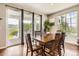 Dining room with wood table set and an outdoor view from sliding glass doors at 9527 Iron Mountain Way, Arvada, CO 80007