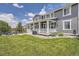 Charming two story home featuring a covered porch, patio, and landscaped yard at 9527 Iron Mountain Way, Arvada, CO 80007