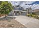 Charming two-story home with a three-car garage, landscaped front yard, and a concrete driveway at 9527 Iron Mountain Way, Arvada, CO 80007