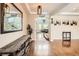 Bright foyer featuring hardwood floors, decorative mirror, and stylish lighting at 9527 Iron Mountain Way, Arvada, CO 80007
