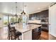 Spacious kitchen with granite countertops, large island, stainless steel appliances, and dark wood cabinets at 9527 Iron Mountain Way, Arvada, CO 80007