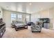 Inviting living room with large windows, comfortable seating, an aquarium, and neutral carpet at 9527 Iron Mountain Way, Arvada, CO 80007