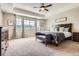 Large main bedroom with a tray ceiling, mountain views and dark wood furniture at 9527 Iron Mountain Way, Arvada, CO 80007