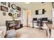 Stylish office space with neutral rug, decorative wall art and shelving, and large windows at 9527 Iron Mountain Way, Arvada, CO 80007