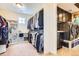 Spacious walk-in closet and laundry room featuring custom shelving, storage, and a modern washer and dryer at 9527 Iron Mountain Way, Arvada, CO 80007