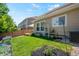 Well-maintained backyard offers a green lawn, charming decor, with potential for recreation and relaxation at 6139 Raleigh Cir, Castle Rock, CO 80104