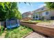 Spacious backyard with a vibrant lawn, trampoline, and garden beds offers lots of room for outdoor enjoyment at 6139 Raleigh Cir, Castle Rock, CO 80104