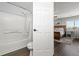 Bathroom with toilet and tub, a bedroom is visible through an open door at 6139 Raleigh Cir, Castle Rock, CO 80104