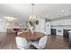 Open dining area showcasing hardwood floors, modern lighting, and seamless access to the kitchen and living room at 6139 Raleigh Cir, Castle Rock, CO 80104