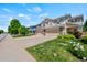 Well-kept townhome featuring a two-car garage, a driveway, and a manicured lawn at 6139 Raleigh Cir, Castle Rock, CO 80104