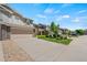 Desirable townhome showcasing a two-car garage, driveway, and front yard with manicured landscaping at 6139 Raleigh Cir, Castle Rock, CO 80104