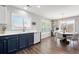 Bright kitchen and dining area with modern lighting, stainless appliances, and hardwood floors at 6139 Raleigh Cir, Castle Rock, CO 80104