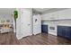 Kitchen with view into living space and featuring white appliances and white and navy cabinets at 6139 Raleigh Cir, Castle Rock, CO 80104