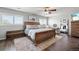 Spacious primary bedroom with a ceiling fan and two windows with plantation shutters at 6139 Raleigh Cir, Castle Rock, CO 80104