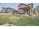 Backyard featuring a pergola, covered seating area and healthy lawn at 10811 Chambers Way, Commerce City, CO 80022
