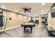 Basement with a billiards table, wet bar, and modern wood laminate flooring at 10811 Chambers Way, Commerce City, CO 80022