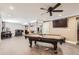 Basement with a billiards table, bar, and modern ceiling fan lighting at 10811 Chambers Way, Commerce City, CO 80022